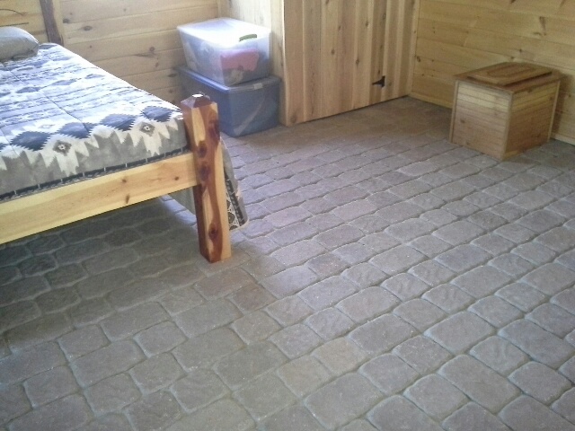 Suzy's hand-laid cobblestone paver-brick floor, tougue-and-groove planked walls, handcrafted mini-4-poster bed.